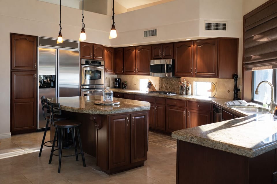The gourmet kitchen features a side-by-side fridge, double oven, microwave, gas 