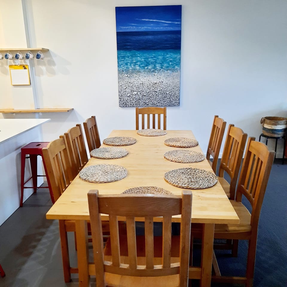 8 seater timber dining table in the open plan kitchen/dining/living area.