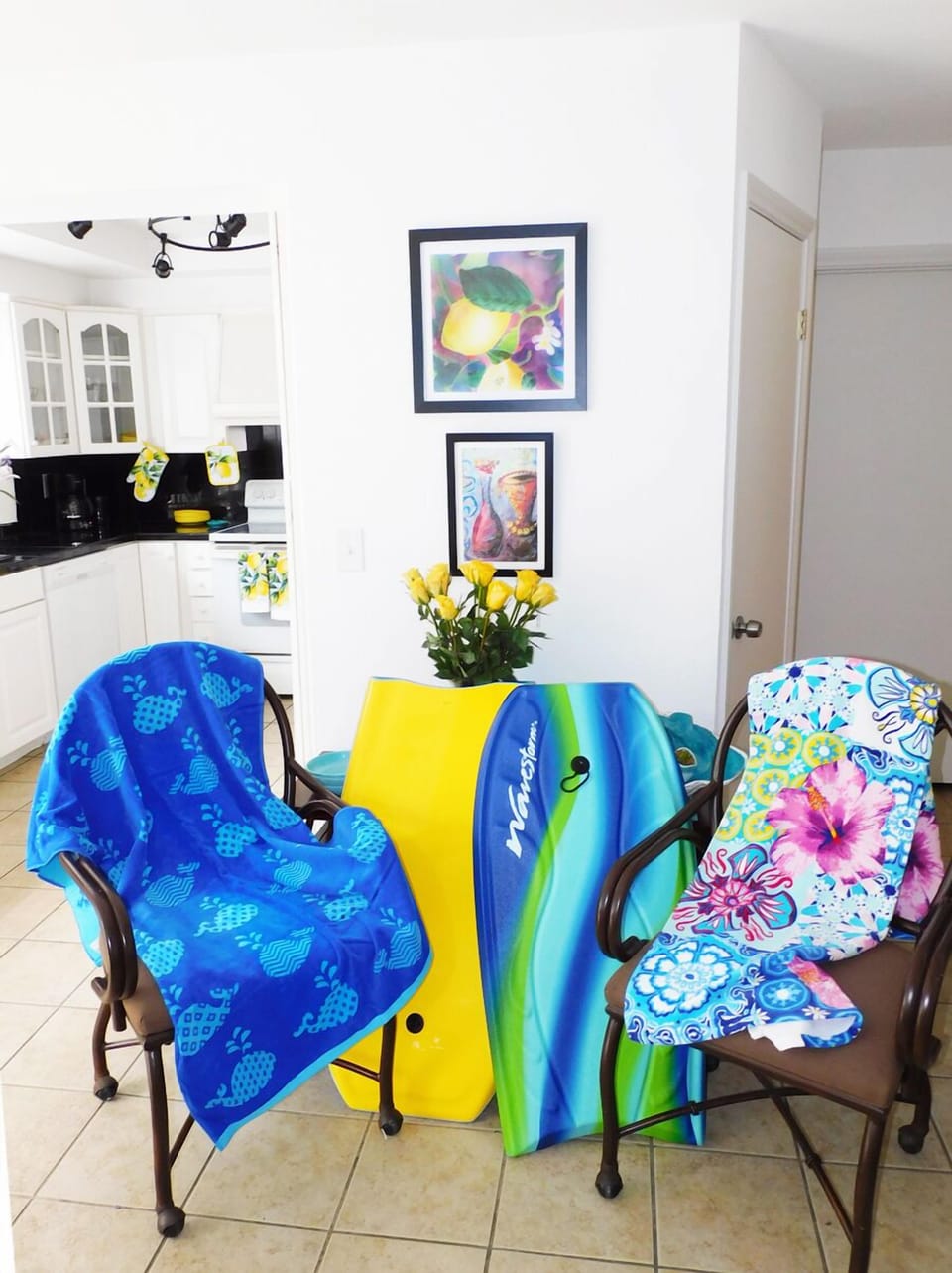 Kitchen area with bodyboards and beach towels included in the unit
