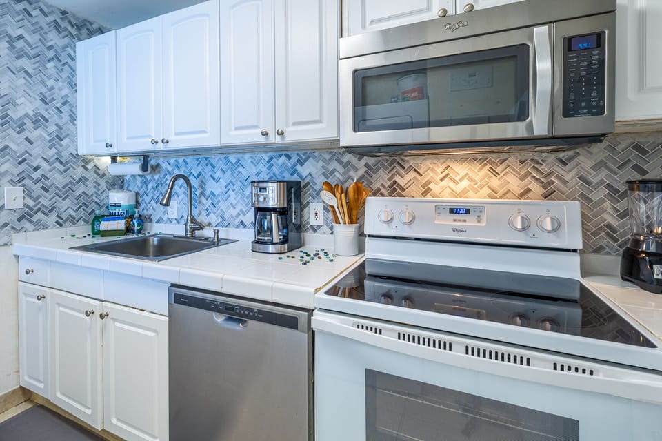 full kitchen with stove, oven, microwave and dishwasher