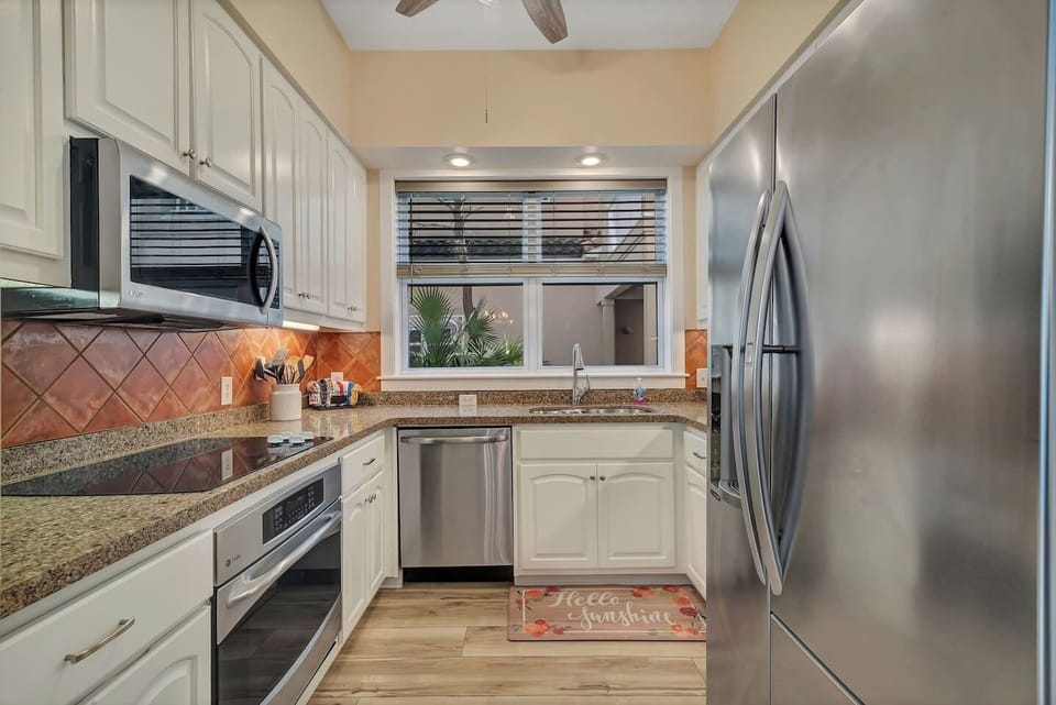 Fully outfitted kitchen with everything needed to cook a family meal. Added touch is a ceiling fan in the kitchen. The fridge has water and ice in the door. 