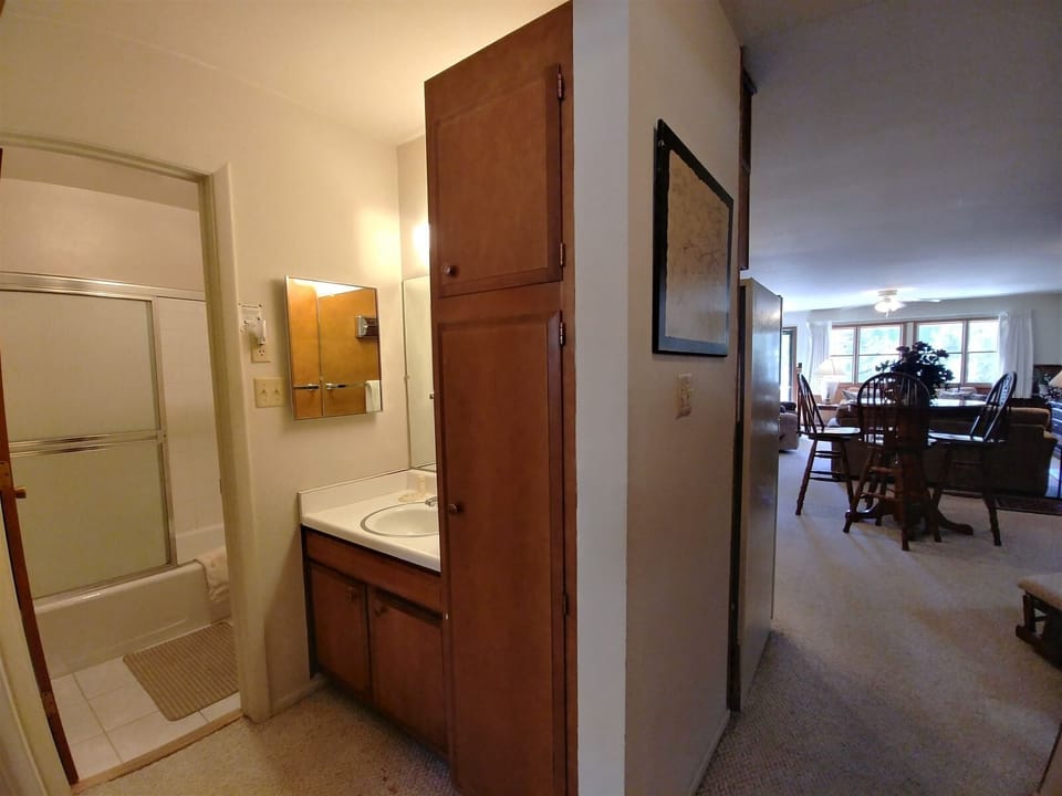 Step into your home away from home, where warm wood tones and thoughtfully designed spaces flow seamlessly. The bathroom awaits just steps away, while the inviting dining area beckons for memorable meals together.