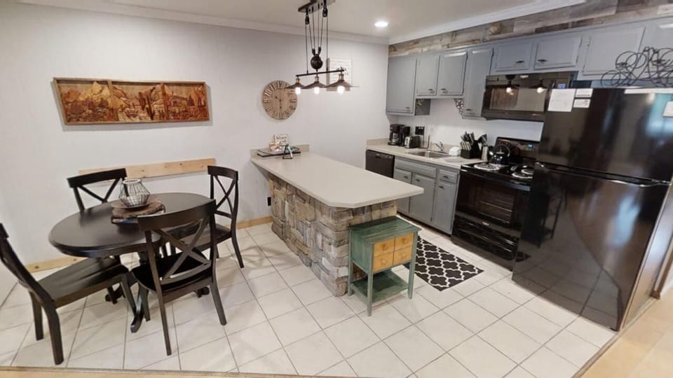 Your home away from home starts here—a fully equipped kitchen and cozy dining nook with rustic charm, perfect for preparing meals and gathering with loved ones.