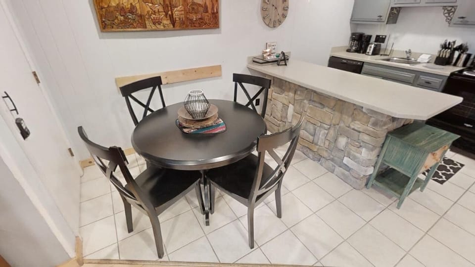 Gather around this cozy dining nook with a rustic stone bar and warm accents—your perfect spot to plan adventures over morning coffee or unwind with evening drinks.