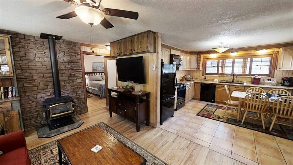 Your cozy cabin retreat blends rustic charm with modern convenience—wood-beam warmth, a crackling fireplace, and a fully equipped kitchen await your mountain getaway.