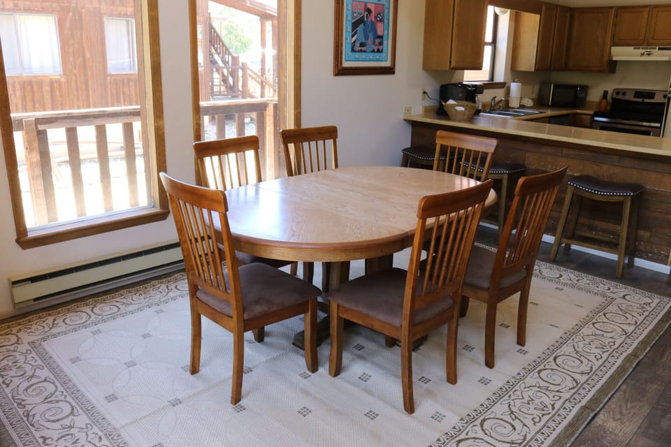 Gather around the inviting dining table with seating for six, perfectly positioned near your fully equipped kitchen and balcony with natural light streaming in.