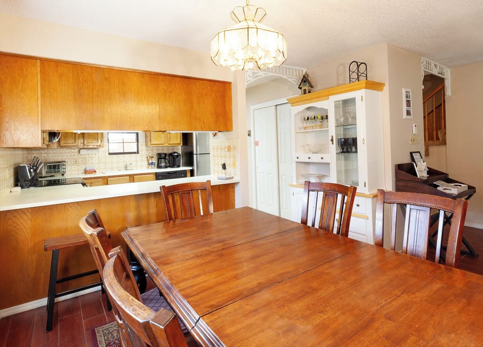 Your spacious dining area flows seamlessly into a well-equipped kitchen, perfect for preparing and sharing memorable meals during your stay.