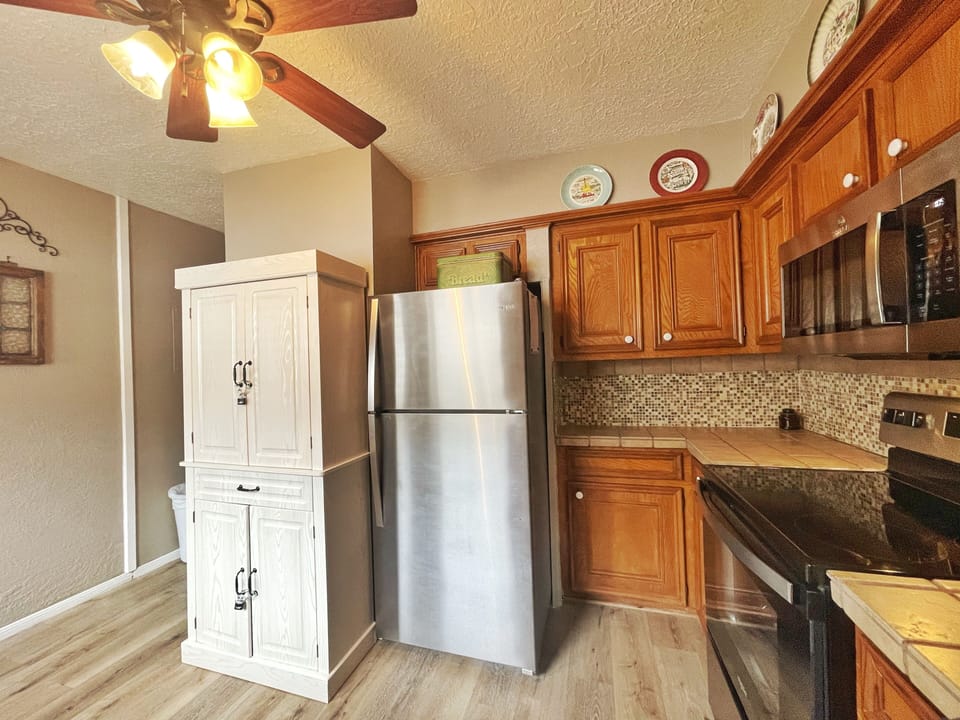 Step into your home-away-from-home kitchen, fully equipped with everything you need to whip up your favorite meals. Warm wood cabinets, modern appliances, and thoughtful touches create a space where cooking feels easy and comfortable.