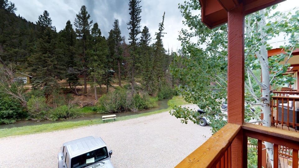 Peaceful forested setting surrounds the property, offering serene natural views and private parking just steps from your mountain retreat.