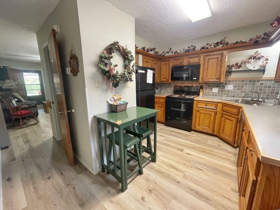 You'll love the fully equipped kitchen with rich oak cabinetry, modern appliances, and charming bistro table—perfect for preparing home-cooked meals during your stay.
