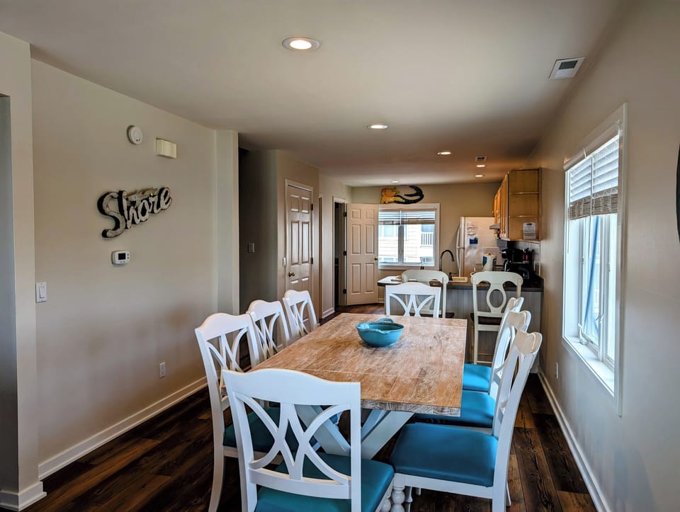38901 Bunting Avenue Open Concept Dining and Kitchen View - A view from the dining area looking toward the kitchen, showing the cohesive hardwood flooring and bright interior.