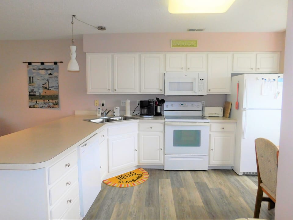 33 Thistle Lane - Fully Equipped Kitchen - Bright kitchen at 33 Thistle Lane featuring white cabinetry, modern white appliances, and a spacious breakfast bar for casual dining.