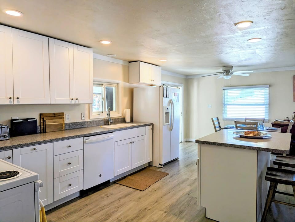 38166 Bow Street, Ocean View - modern kitchen - Updated kitchen featuring sleek white cabinetry, expansive counter space, and modern recessed lighting for a bright workspace.