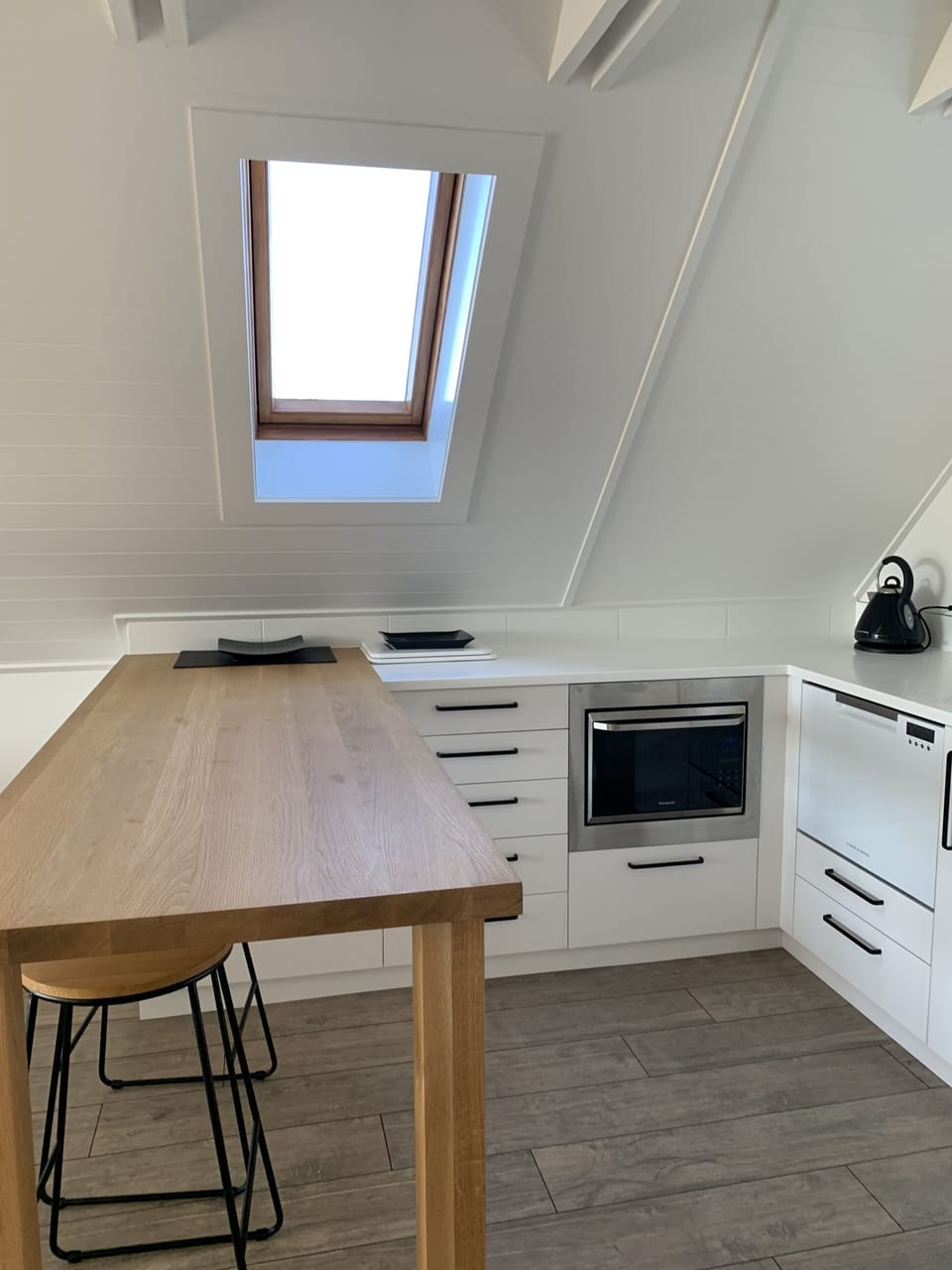 Convection oven/microwave, dishwasher and breakfast bar in kitchen area.