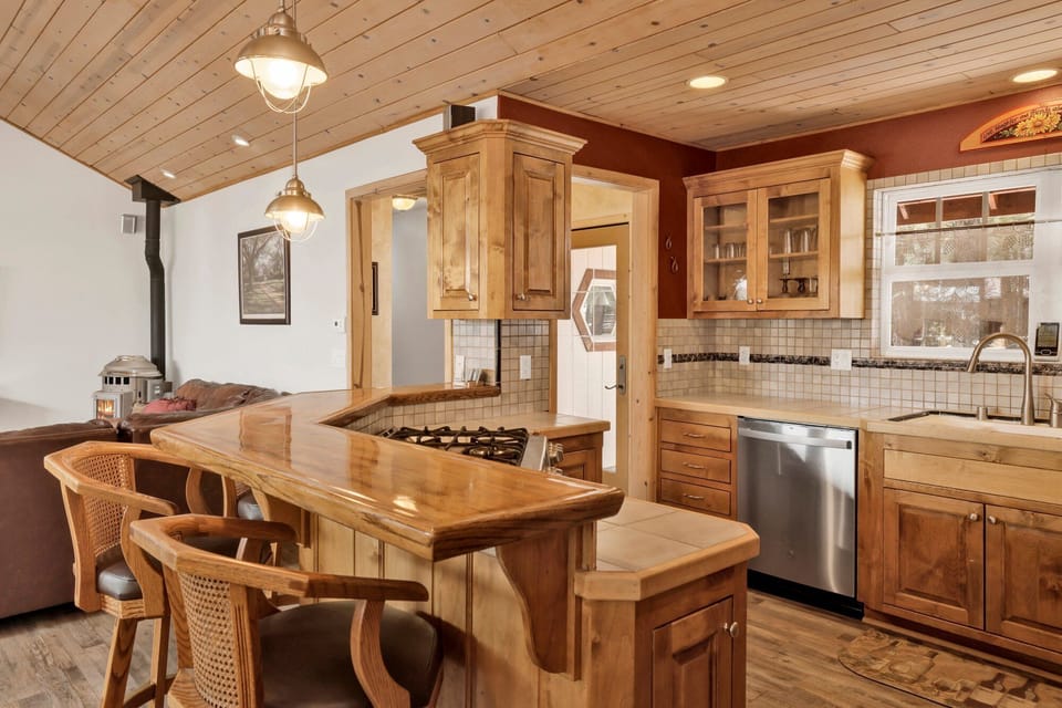 Fully equipped cabin kitchen with ample cabinetry, stove, fridge, microwave, and coffee maker—perfect for cooking meals, morning coffee, and feeling right at home on your stay.