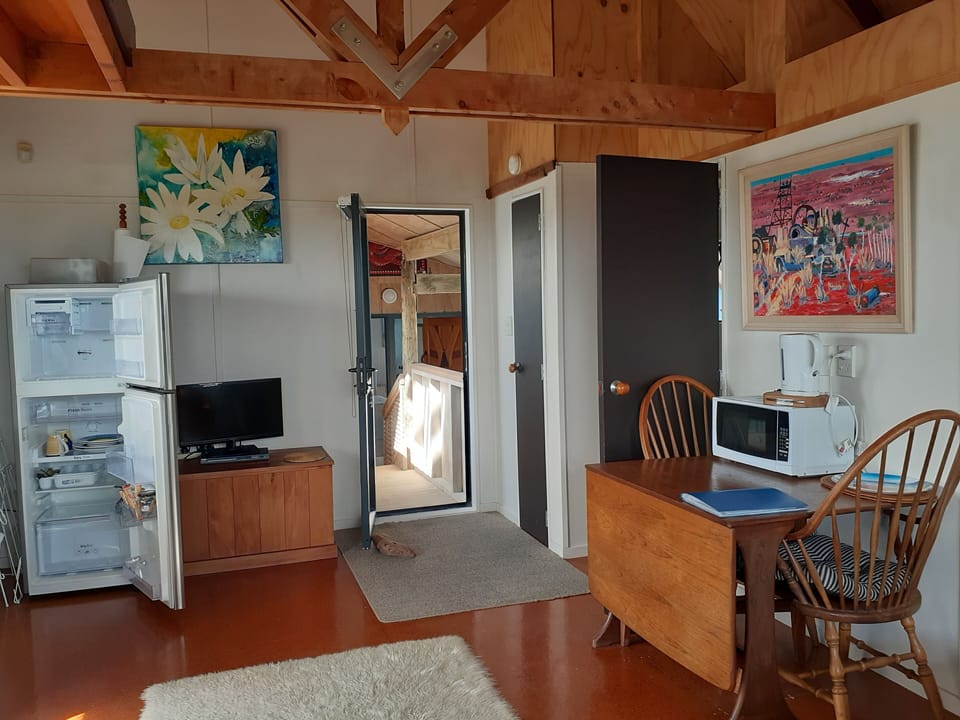 Fridge/freezer, crockery, dining table, jug, toaster, microwave 
