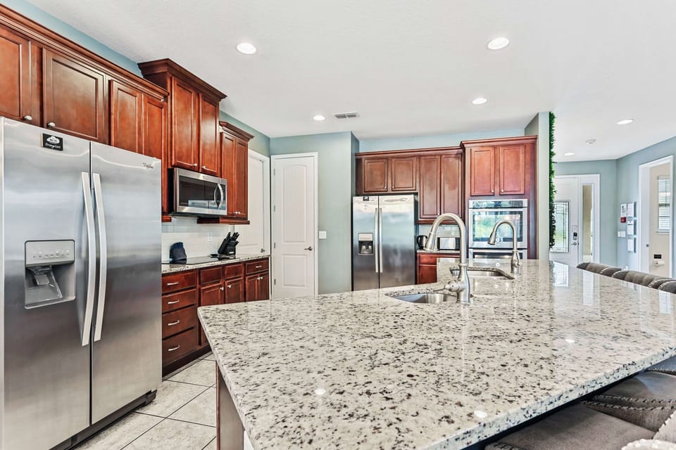 The open concept kitchen has two ovens, two dishwashers and two refrigerators!