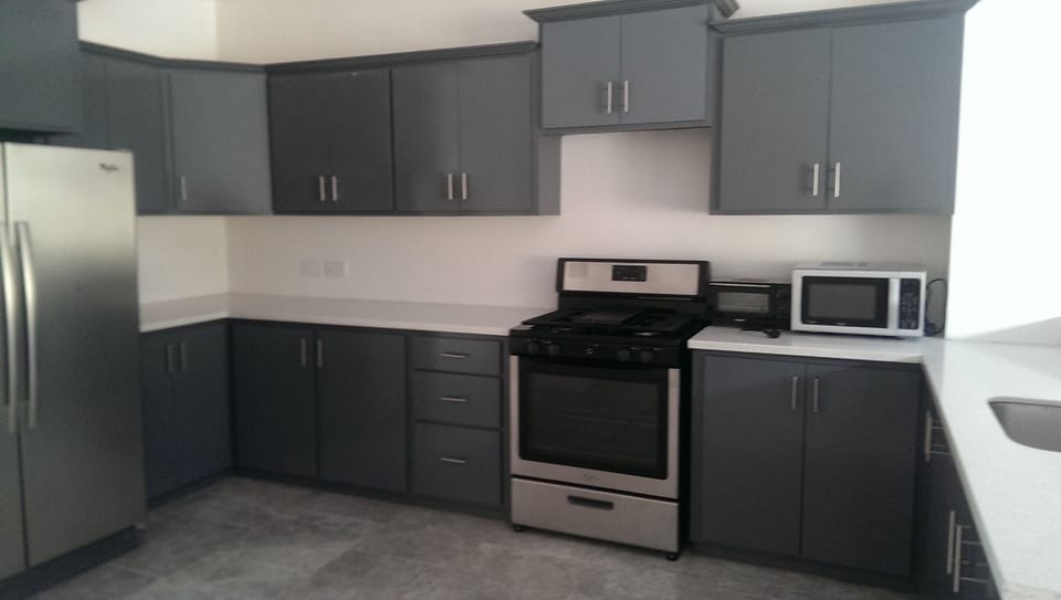 Spacious and fully furnished kitchen with stainless steel appliances.