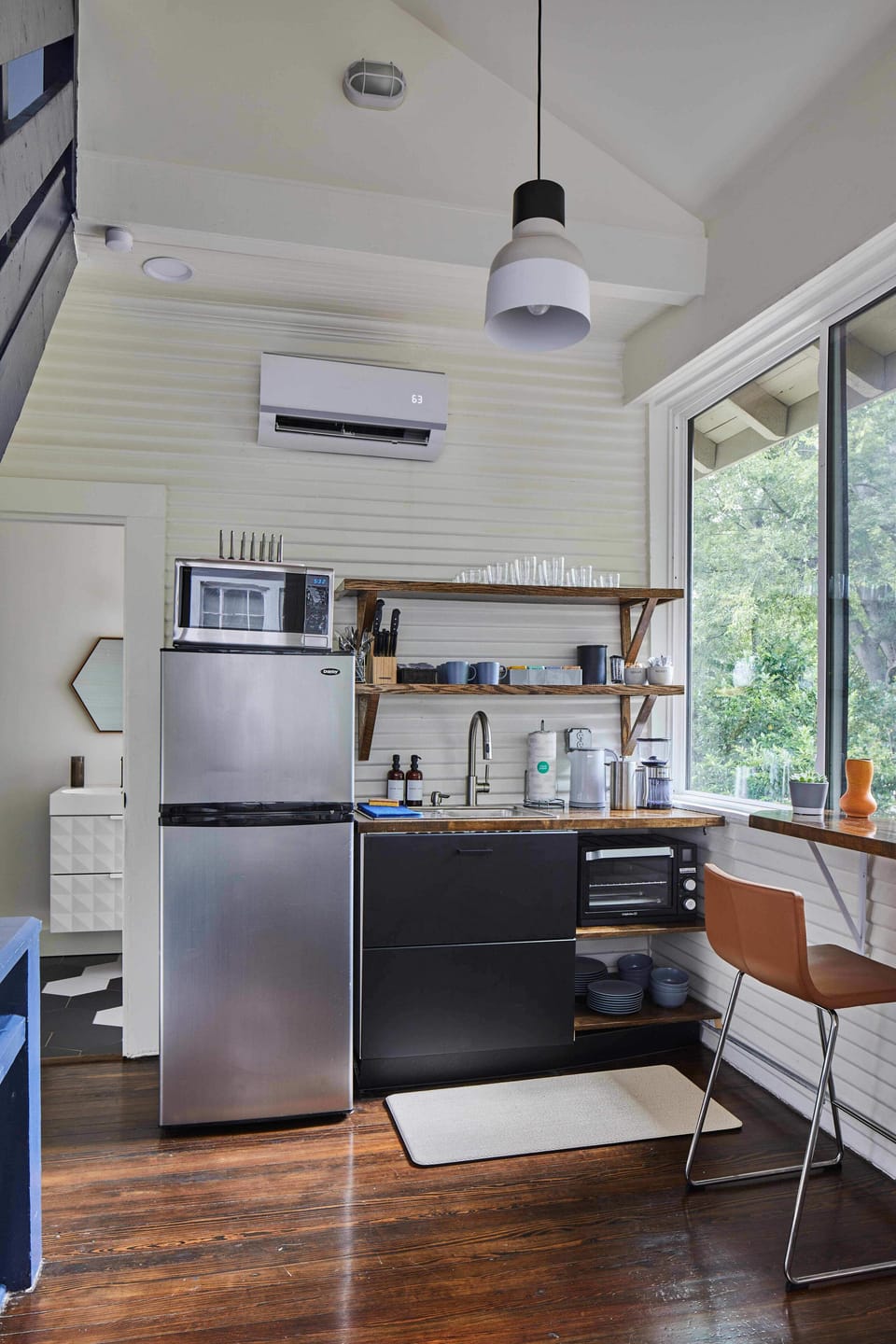The sun-filled dine-in kitchen and bathroom are on the lower level of the apartment.