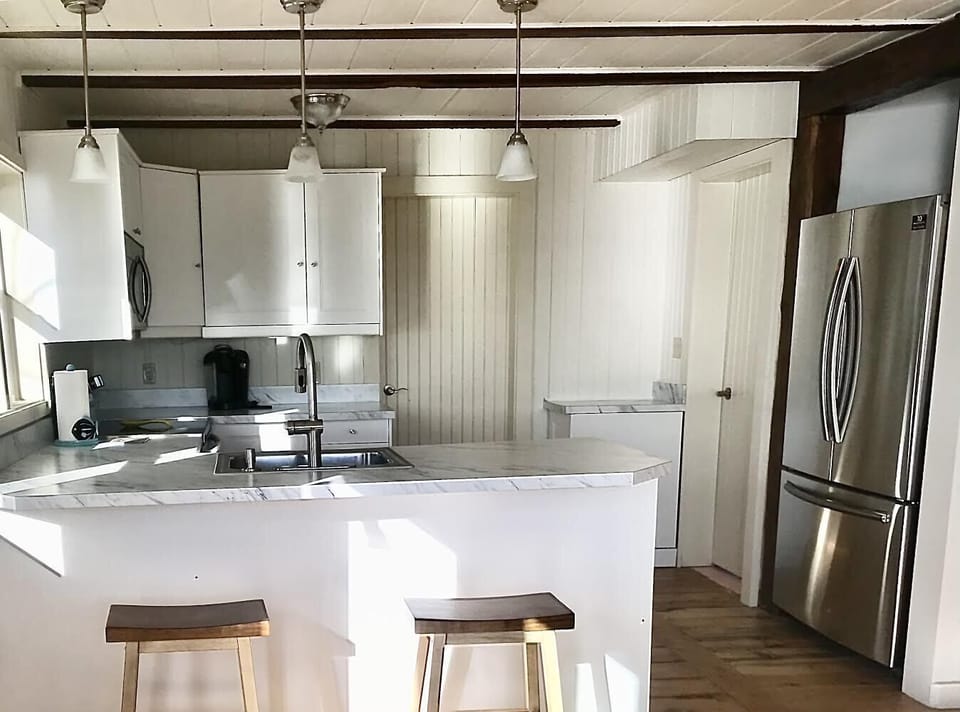 New well-equipped kitchen with stainless steel appliances.