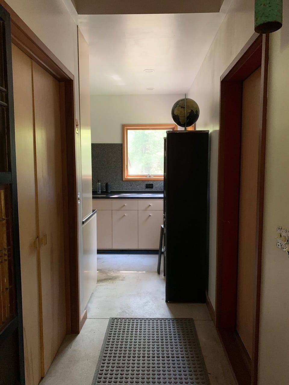 View into entry and kitchen beyond
