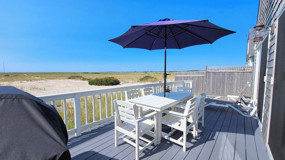 You may never leave the deck with gas grill, dining table and loungers