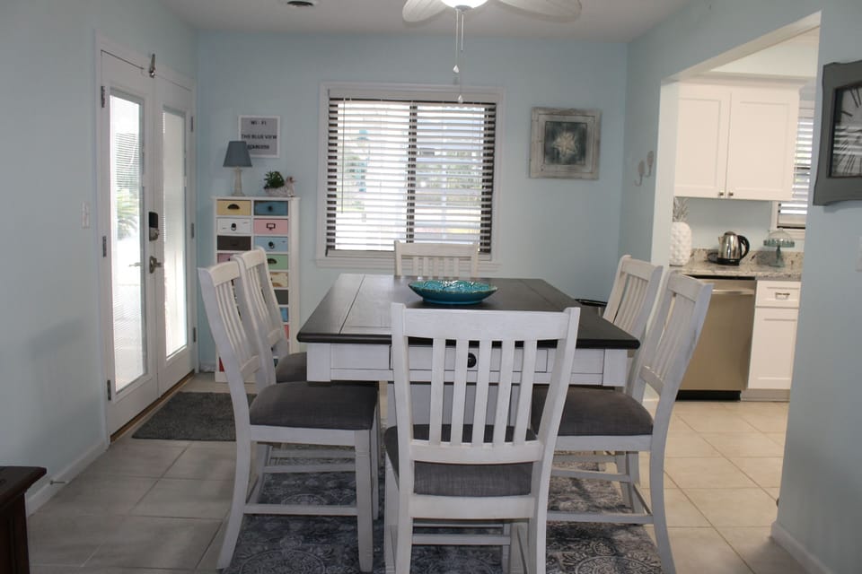 View of dining area, kitchen and back door