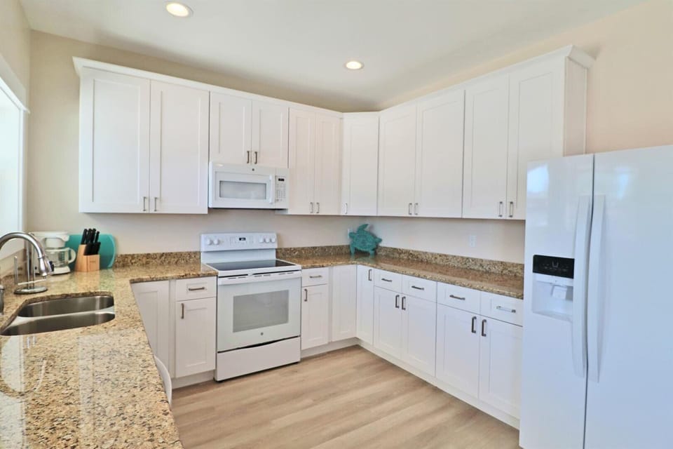 The white kitchen and abundance of windows in Unit A provide tons of natural light.