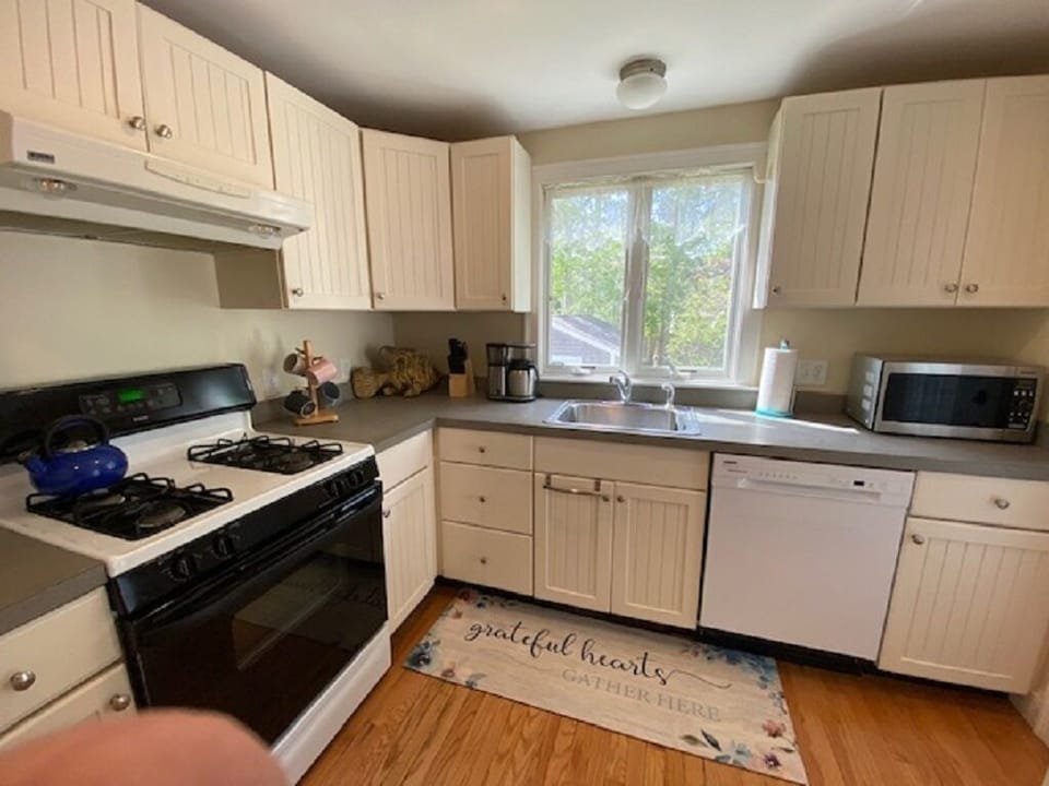 Kitchen with stove, microwave, dishwasher and refrigerator