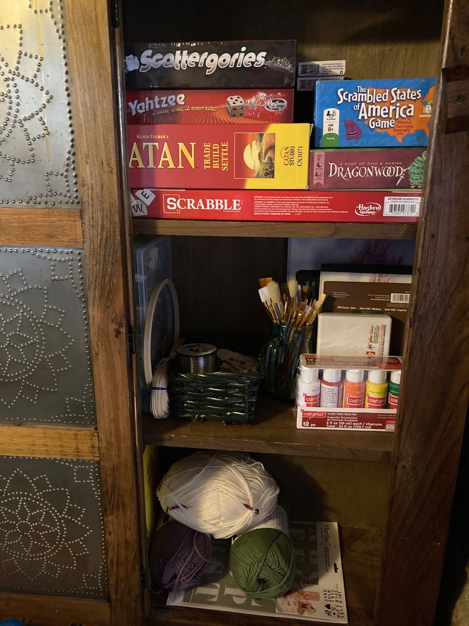 This entertainment cabinet provides games and art supplies to help you unwind.