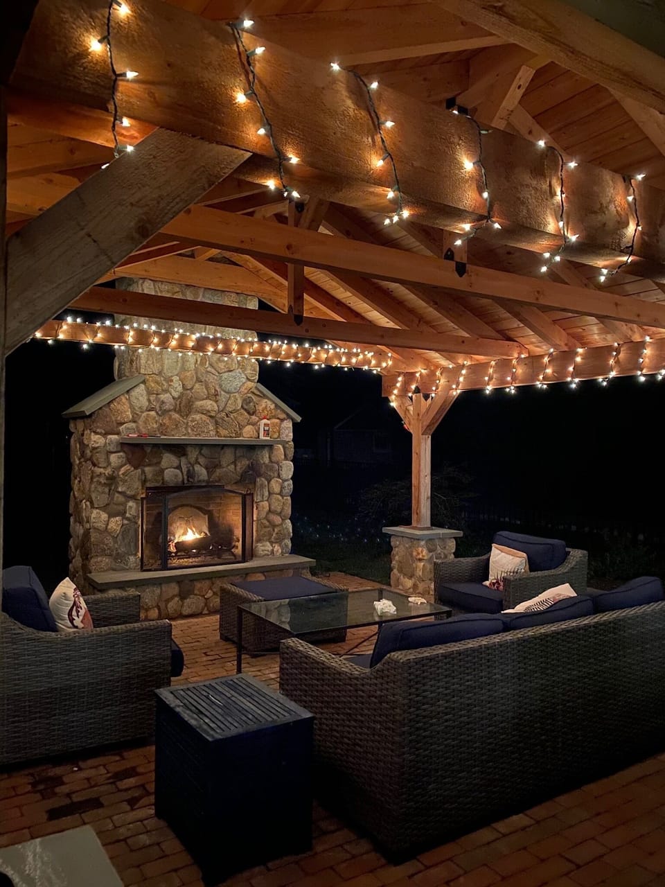 outdoor fireplace and lounge area, with pergola