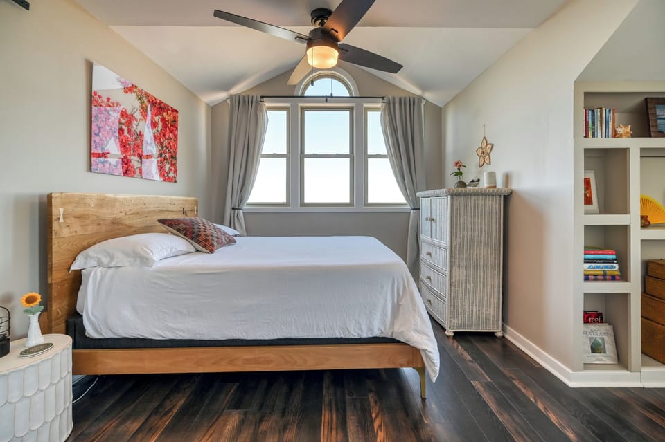 Master queen bedroom w/ en suite bathroom, closet & dresser with smart TV inside