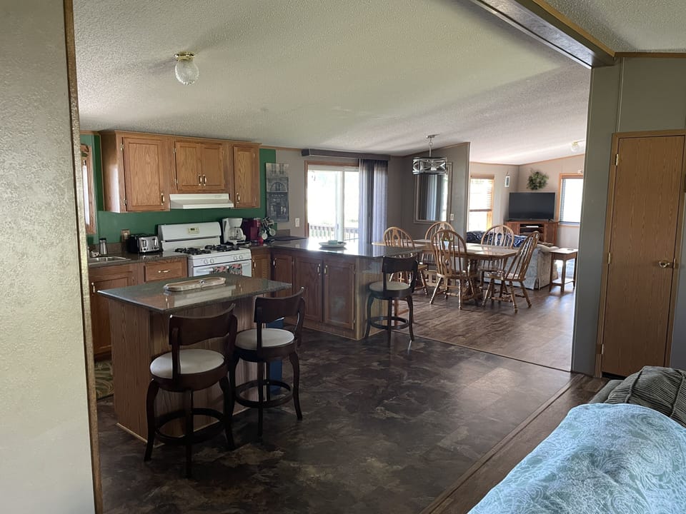 kitchen area and island, breakfast bar, dining room and front living room 