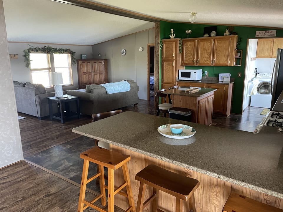 breakfast bar, kitchen and entry side living room area