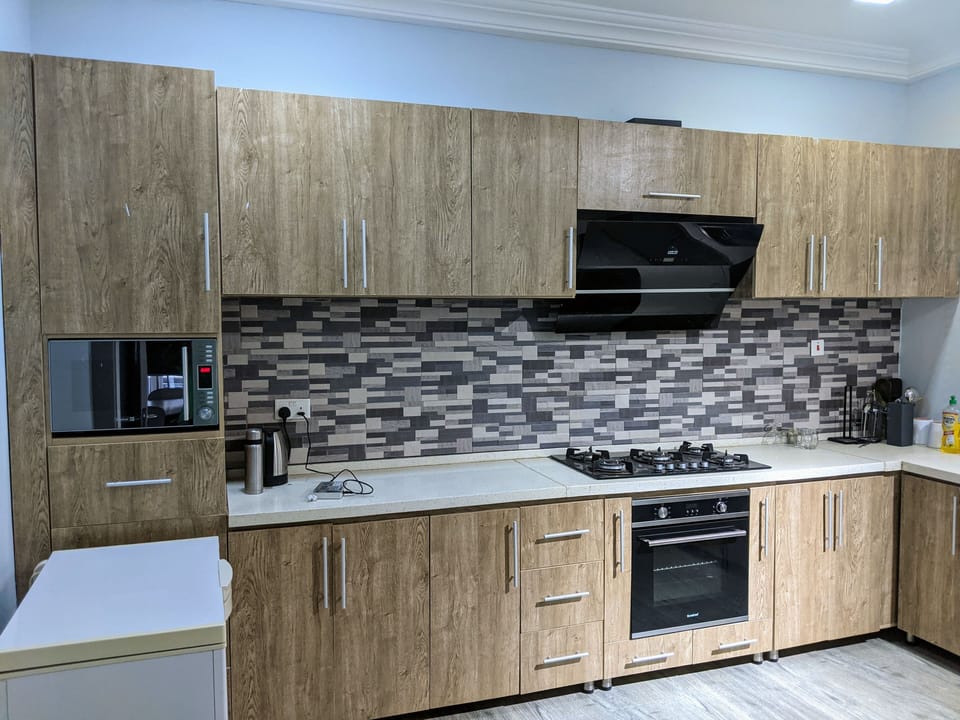 Kitchen: Microwave, freezer, electric kettle and gas hob burner
