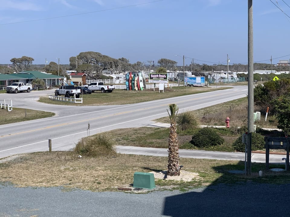 Street side of house, Beach Bums bar & grill and beach rental across the street