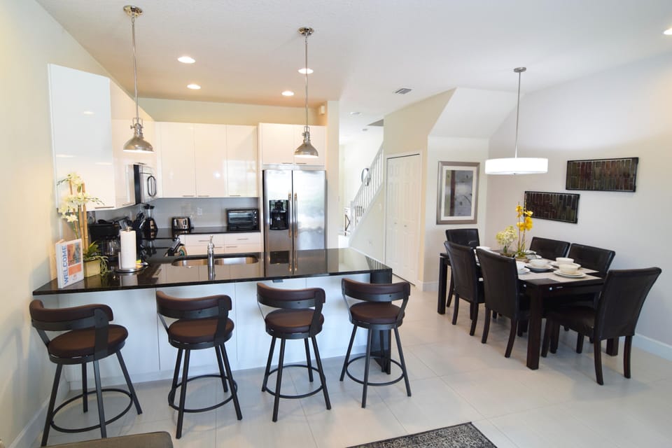 Modern kitchen with formal dining area for six guests