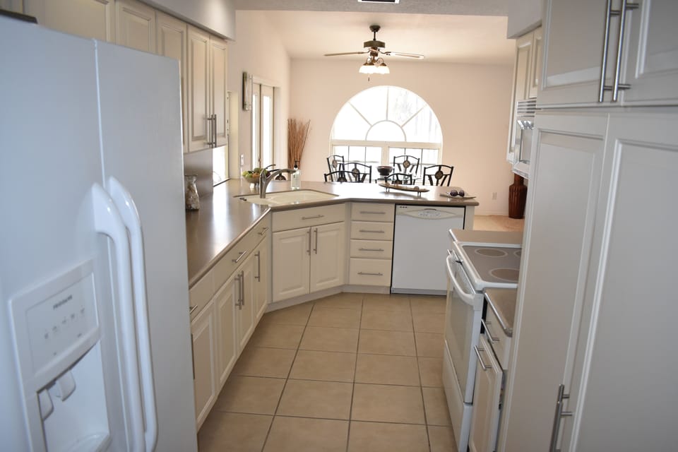 Entry into the kitchen area w/ fabulous immediate waterway views. Corian counter