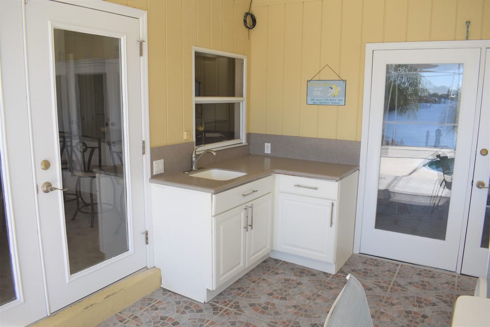 Outdoor kitchenette tiled w/ sink, counter,  (Webber gas grill not pictured) 