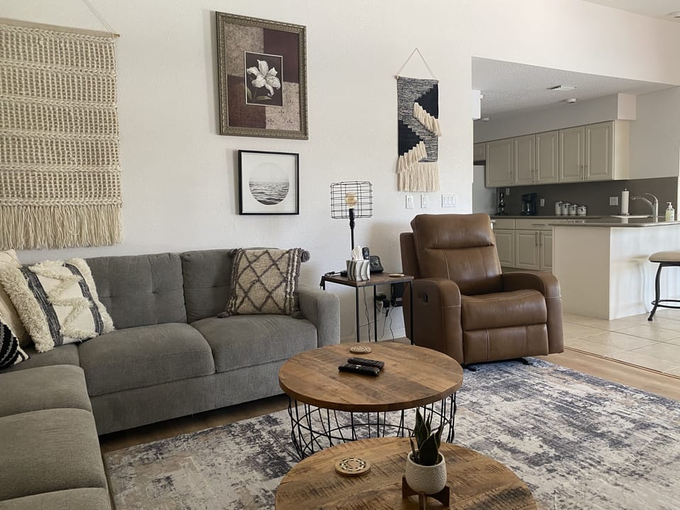 Sectional seating w/ luxurious recliner rocker. Vaulted ceiling & soft area rug