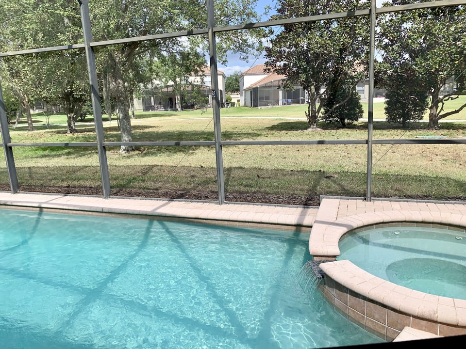 Pool & Spa with green space behind the house 