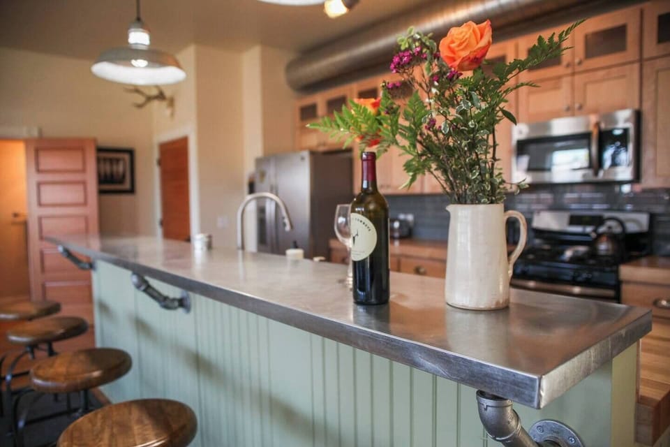 Luxury living: pull up a stool to the kitchen bar and enjoy a meal, a cocktail & great conversation.