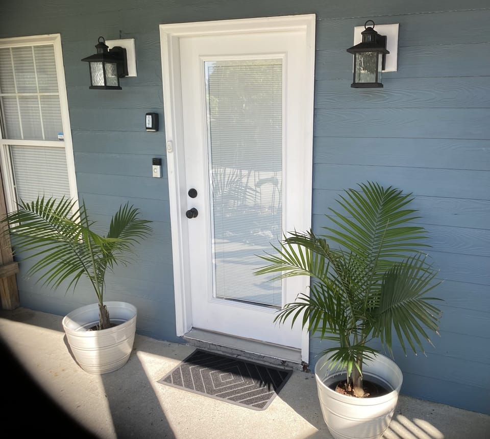Front door. Lock Box on left side. You must enter the code to close the lock box