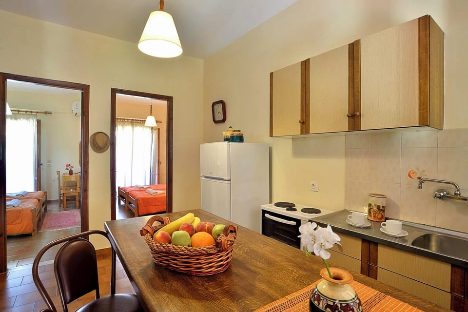 With: mini oven, stove 2-3 burners, fridge, coffee machine, kettle, pots & pans