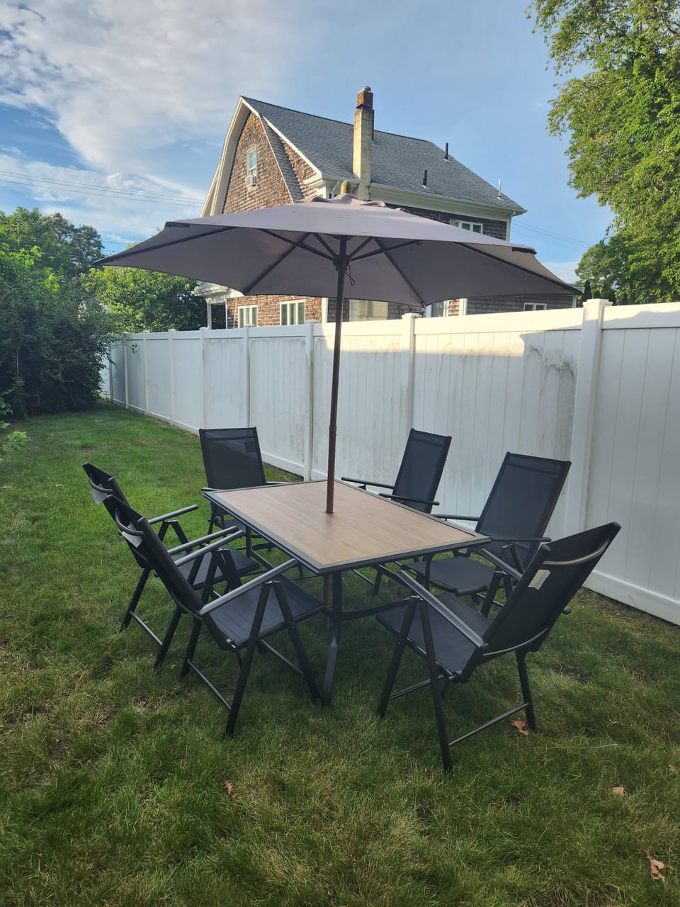 Private backyard with outdoor furniture and grill