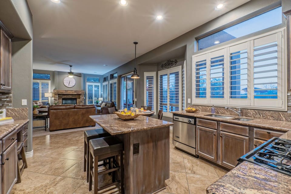 The many large windows illuminate the back of the home and provide stellar views of the backyard oasis.