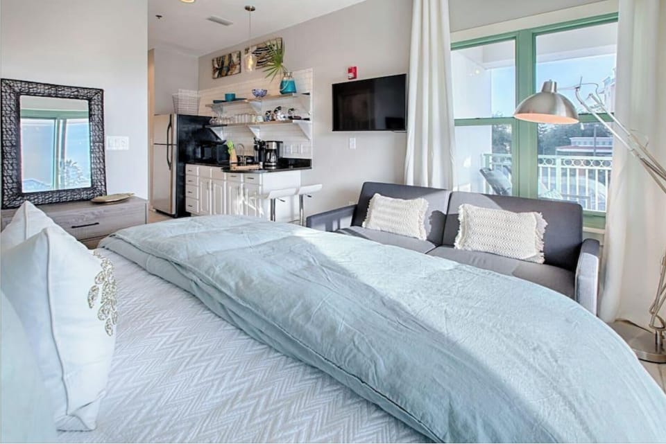 Your modern studio sanctuary features a plush king bed, full kitchen, and cozy seating area—perfect for relaxing after exploring the city.