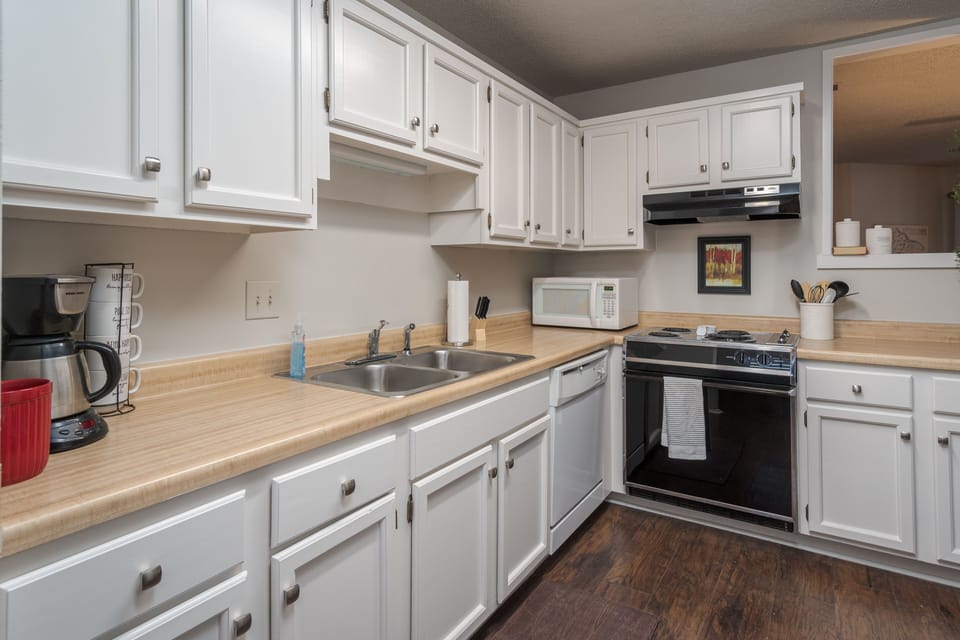 It has a coffee maker, microwave, full oven and 4 burner stove.