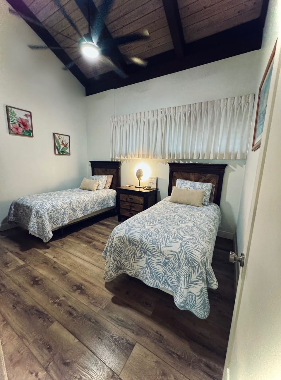 Second bedroom with vaulted ceilings, 2 twin beds, and smart tv