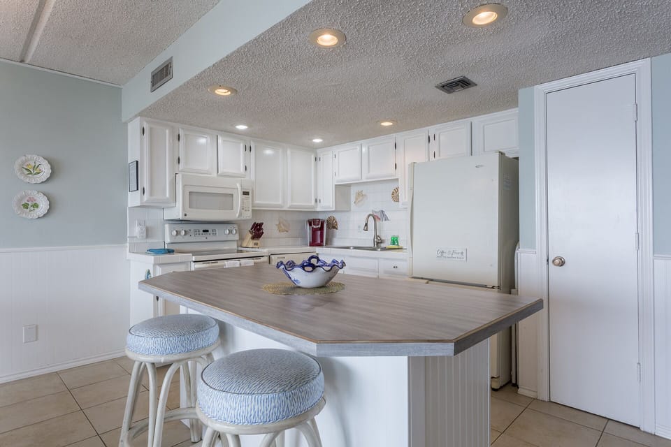 Fully equipped kitchen with pots, pans, cooking utensils, and glassware essential to prepare a home cooked meal!